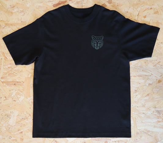 Black t-shirt with a bear logo on a wooden surface